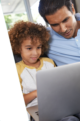 Photo of a parent and child looking at the screen of a laptop computer.