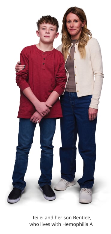 a woman and her son standing together looking at the camera