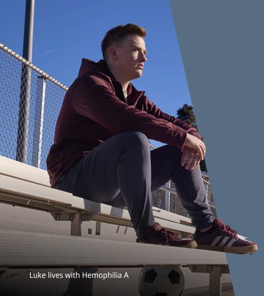 person sitting on bleachers outdoors looking into the distance