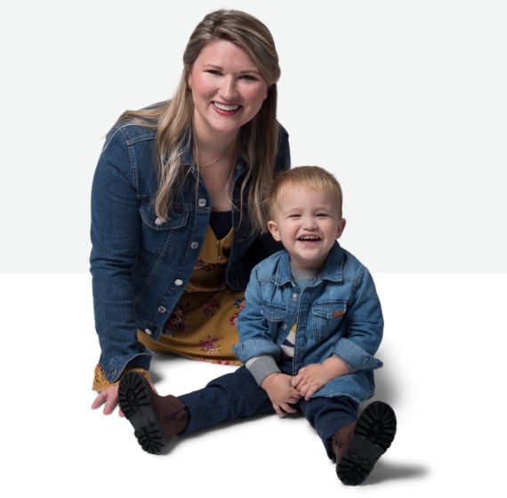Snapshot of Emili, an advocate for Rebinyn® [Rebinyn Coagulation Factor IX (Recombinant), GlycoPEGylated ] kneeling next to her son Xander, who has mild hemophilia B. They are smiling and happy.